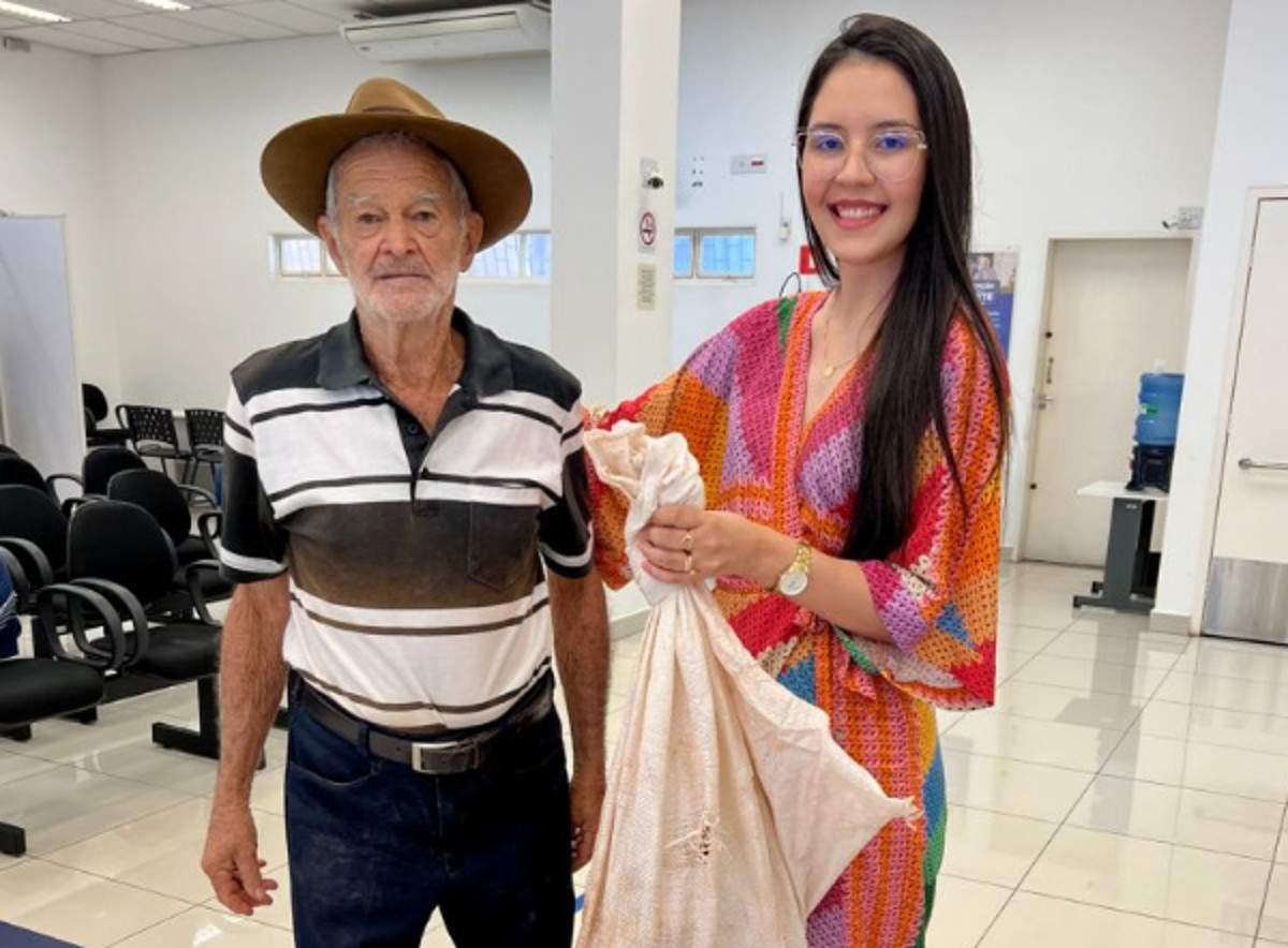 idoso presentenia gerente de banco com galinha - foto
